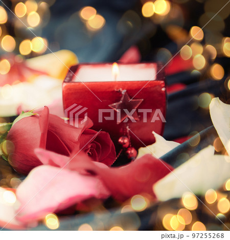 box with ring and rose petals in black silk background. Beautiful bokeh effect from a garland. box with ring and rose petals in black silk background. Beautiful bokeh effect from a garland. 97255268