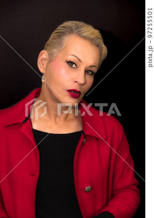 Attractive blonde woman wearing a red coat 97255501
