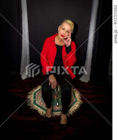 Attractive blonde woman wearing a red coat 97255502