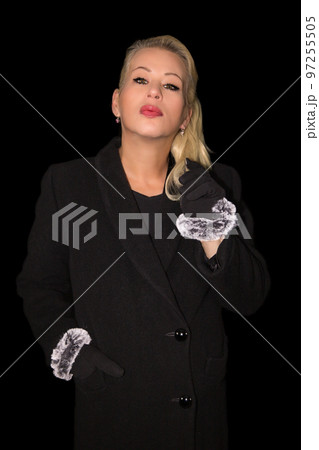 Attractive blonde woman wearing a black cashmere coat Attractive blonde woman wearing a black cashmere coat 97255505