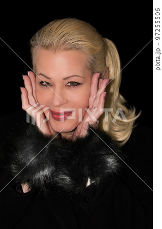 Attractive blonde woman wearing a black cashmere coat Attractive blonde woman wearing a black cashmere coat 97255506