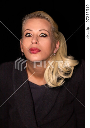 Attractive blonde woman wearing a black cashmere coat Attractive blonde woman wearing a black cashmere coat 97255510