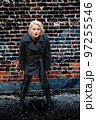 Fashionable blonde woman walking exploring the city. 97255546