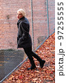 Fashionable blonde woman walking exploring the city. 97255555