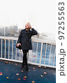 Fashionable blonde woman walking exploring the city. 97255563