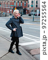 Fashionable blonde woman walking exploring the city. 97255564