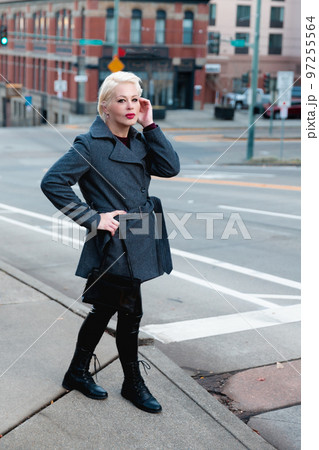 Fashionable blonde woman walking exploring the city. Fashionable blonde woman walking exploring the city. 97255564