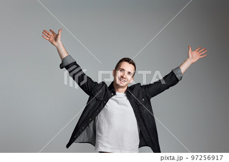 amazed man celebrating victory on gray background. 97256917