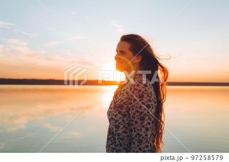 Portrait happy laughing woman in pink dress Portrait happy laughing woman in pink dress 97258579