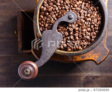 Roasted coffee beans in old coffee grinder. 97260690