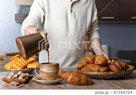 Breakfast with black coffee, freshly baked waffles and croissants Breakfast with black coffee, freshly baked waffles and croissants 97260704