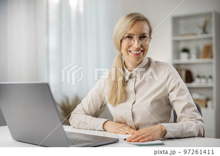 Businesslady smiling to camera Businesslady smiling to camera 97261411