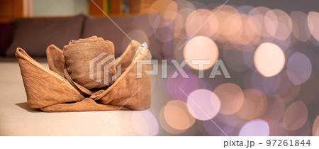 Yellow towel on bed decoration in bedroom interior, Freshly laundered fluffy towels, Towel in hotel room, Beautifully folded toiletries Yellow towel on bed decoration in bedroom interior, Freshly laundered fluffy towels, Towel in hotel room, Beautifully folded toiletries 97261844