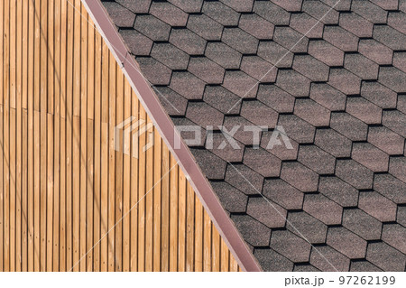 Modern building roofing element with tiled roof and wood wall facade exterior interior background 97262199