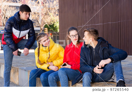 Teenagers gathering outdoors Teenagers gathering outdoors 97265540