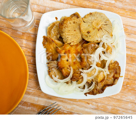 Salad of pickled wild mushrooms and sliced onion on plate Salad of pickled wild mushrooms and sliced onion on plate 97265645