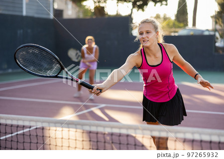 Woman tennis player training on court Woman tennis player training on court 97265932