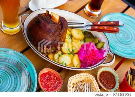 German pork hock with sliced potato and marinaded foods German pork hock with sliced potato and marinaded foods 97265955