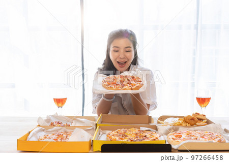 Portrait of Asian celebrate Christmas with champagne and eating pizza at home. Joy of holiday party with friends or colleague concept 97266458