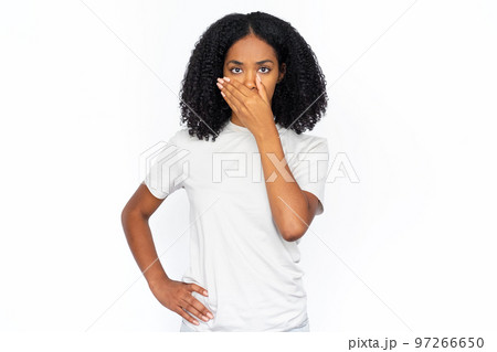 Serious African American woman covering mouth Serious African American woman covering mouth 97266650
