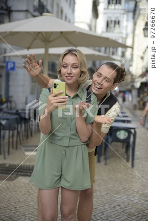 Joyful tourist couple making video call Joyful tourist couple making video call 97266670