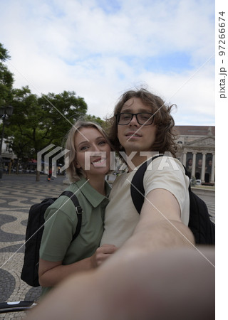 Smiling tourist couple taking selfie 97266674