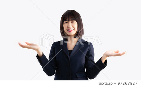 Asian businesswoman short hair style smiling and looking camera posing hands pointing on white background. Asian businesswoman short hair style smiling and looking camera posing hands pointing on white background. 97267827