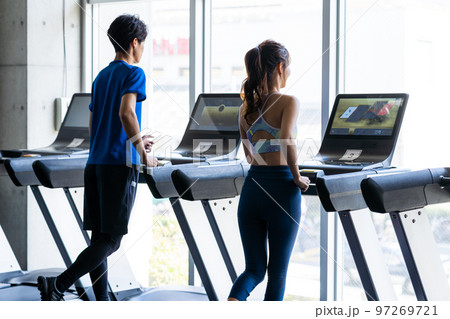 スポーツジムでトレーニングする若い男女 97269721