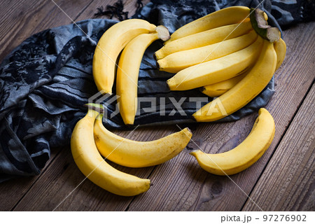 bunch of bananas - banana on wooden background, ripe banana fruit on floor 97276902