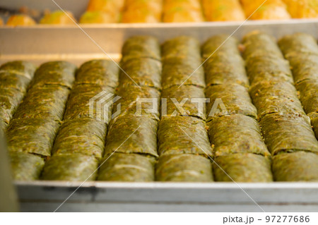 Various types or many colorful assortment of Turkish sweets for sale in street shop food festival. Baklava and pastries are sold on trays on the counter. Travel Various types or many colorful assortment of Turkish sweets for sale in street shop food festival. Baklava and pastries are sold on trays on the counter. Travel 97277686