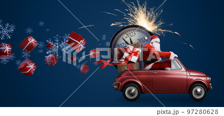 Christmas is coming. Santa Claus on toy car delivering New Year 2023 gifts and countdown clock at blue background with fireworks Christmas is coming. Santa Claus on toy car delivering New Year 2023 gifts and countdown clock at blue background with fireworks 97280628