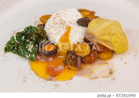 Recipe for braised cabbage, multicoloured carrots, onions, chanterelle mushrooms, poached egg and 97281049