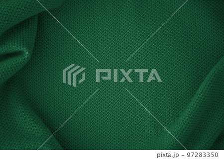 Texture of knitted fabric in trendy green color 97283350