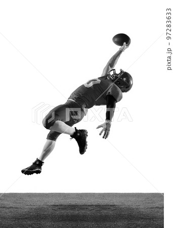 Monochrome portrait of professional american football player in sports uniform and protective helmet in motion isolated over white background. Monochrome portrait of professional american football player in sports uniform and protective helmet in motion isolated over white background. 97283633