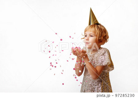 Happy child girl blowing confetti 97285230