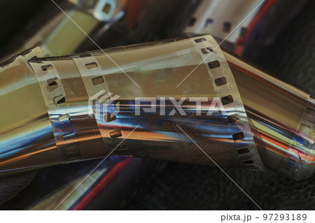 Twisted old film for photo, video camera close up. Concept of photographic memories Twisted old film for photo, video camera close up. Concept of photographic memories 97293189