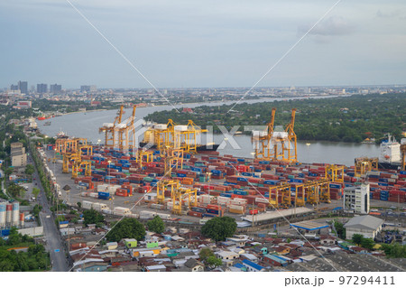 Aerial view of container cargo ship in the export and import business and logistics international goods in urban city. Shipping to the harbour by crane in Bangkok harbour, Thailand. Aerial view of container cargo ship in the export and import business and logistics international goods in urban city. Shipping to the harbour by crane in Bangkok harbour, Thailand. 97294411
