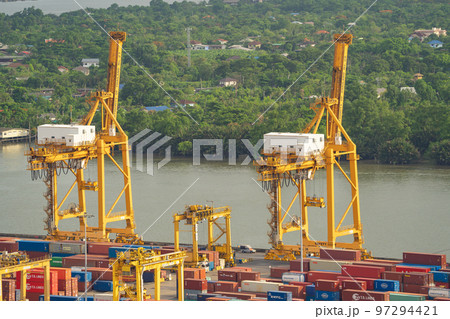 Aerial view of container cargo ship in the export and import business and logistics international goods in urban city. Shipping to the harbour by crane in Bangkok harbour, Thailand. 97294421