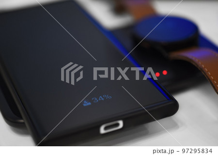 Smartphone and watch charging on wireless charger Smartphone and watch charging on wireless charger 97295834