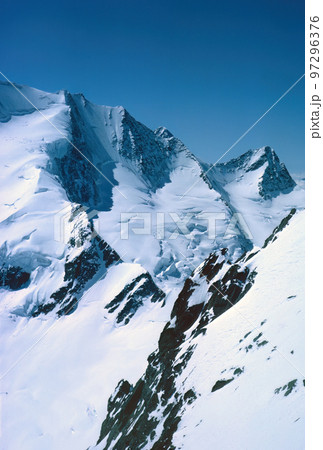 Panorama of snowy mountains and high alpine peaks in wintery Bernese Oberland in Switzerland Panorama of snowy mountains and high alpine peaks in wintery Bernese Oberland in Switzerland 97296376