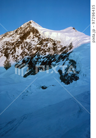 Panorama of snowy mountains and high alpine peaks in wintery Bernese Oberland in Switzerland 97296435