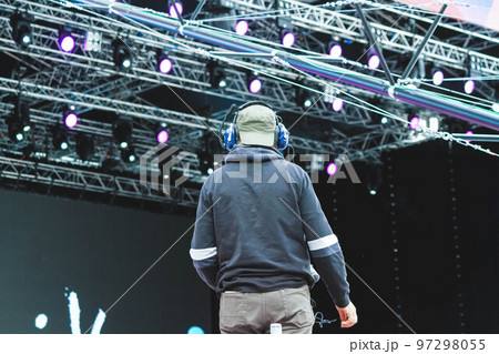 The operator with a video camera shoots a concert. Shooting video at the event. 97298055