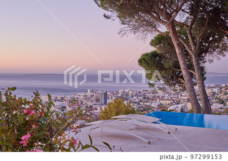 Aerial view of sea point, Cape Town during sunset. The beautiful landscape panorama of South Africa with copy space and sea horizon touching the sky. Scenic view of a town with skyscrapers and trees 97299153