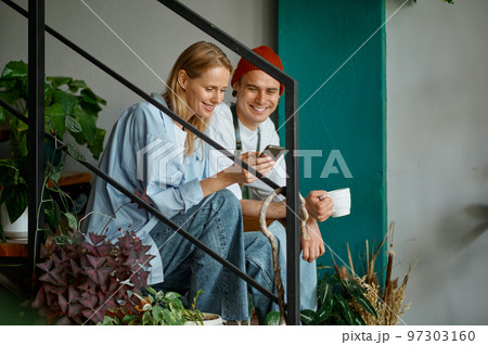 Happy decorators taking break during work at creative art studio 97303160