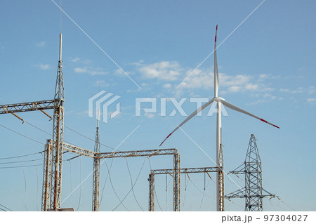 Windmill supports functioning of substation against sky Windmill supports functioning of substation against sky 97304027