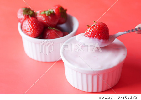 Yogurt and strawberry in a bowl on white Yogurt and strawberry in a bowl on white 97305375