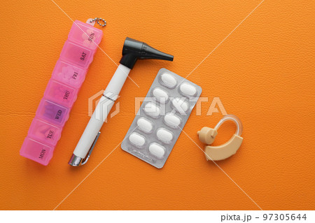 Hearing aid equipment and medicine on table top view Hearing aid equipment and medicine on table top view 97305644