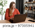 Woman working on laptop 97305941