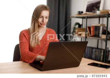 Woman using laptop at home Woman using laptop at home 97305943