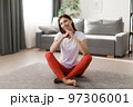 Smiling woman resting during sport 97306001